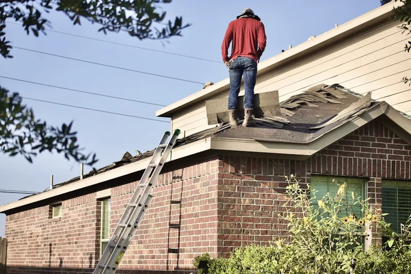 Professional roofer working on a residential roof in Eastside Passaic